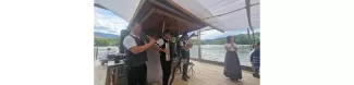 folklore group playing music on the timber raft on the river