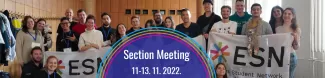 a group photo with ESN flags, the text Section Meeting displayed in the middle