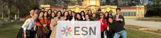 International students inside Giardini Ducali with ESN Modena flag