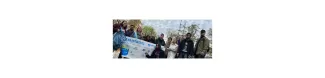 A group of people standing in front of a pond, holding the banner of the organization "Initiatives Océanes".