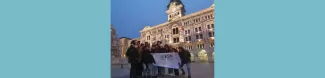 15 students standing in front of the Town Hall of Trieste with the flag of ESN Trieste after the City tour.
