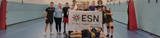 People after playing volleyball with ESN flag