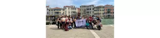 Group picture near Canal Grande with the flag of ESN Venezia