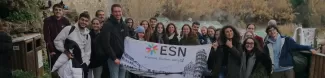 Group of people in front of the falls with the ESN flag