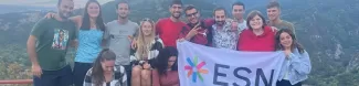 Erasmus studend with ESN flag in a trip to Asenovgrad