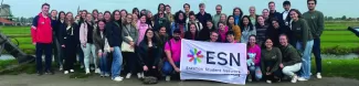 The group posing together with the ESN flag