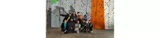 ESNers taking a group photo. Behind, a climbind wall