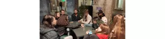 Ten people playing at "Uno"