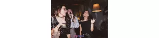 Three girls singing with the microphone