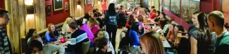 A shot of the teams discussing an answer during the pub quiz