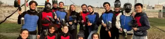 Group of international students on a paintball pitch