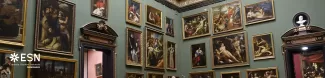 The image displays a wall from a museum salon full of paintings