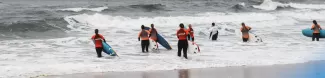 Group of international students doing a surf class.