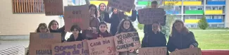 International students holding painted banners with reivindicative statements for women's rights