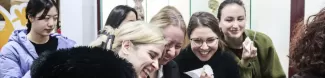 A group of Erasmus laughing while eating a Ovo Mole