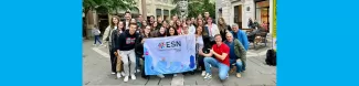 A group picture with the owners of the 4 ice cream shops that we visited. The participants are holding our section's flag.