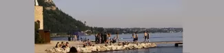 People at the beach surrounding the lake