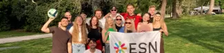 people holding a esn flag in the park