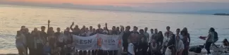 people standing for a photo on a beach