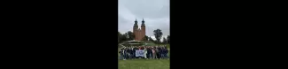 group of international students standing with section flag in Gniezno