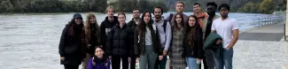 A group of internationl students posing for a group picture in Dürnstein next to the river Danube.