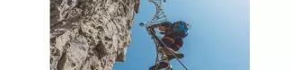 Image of a man climbing a via ferrata