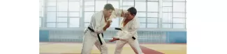 2 persons fighting in a martial art combat