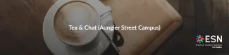 A cappuccino in a white cup on a wooden table with a spoon on the saucer. Text "Tea & Chat (Aungier Street Campus)" is in the centre. ESN TU Dublin logo is on the right.
