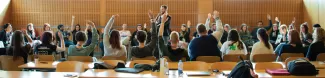 Students raising hands during a workshop